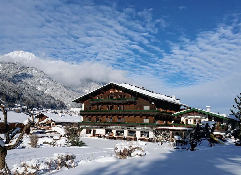 Familien- & Vitalhotel Auenhof in Fulpmes with snowy alpine mountain views and chalet-style exterior