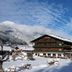 Familien- & Vitalhotel Auenhof in Fulpmes with snowy alpine mountain views and chalet-style exterior