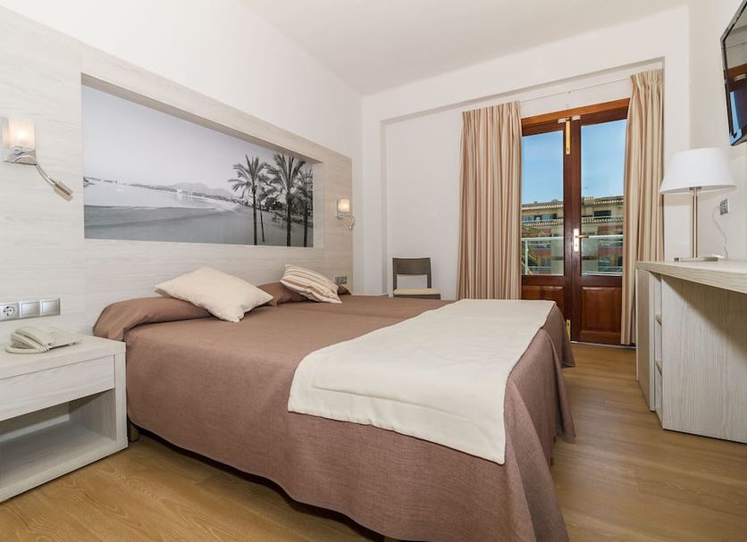 Eix Alcudia Hotel +18 room with double bed, balcony doors and coastal wall art in Alcúdia