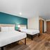 WoodSpring Suites San Antonio South guest room with two beds and desk in San Antonio