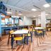 Fairfield Inn & Suites by Marriott Ottawa Airport dining area with tables, chairs and breakfast bar in Ottawa