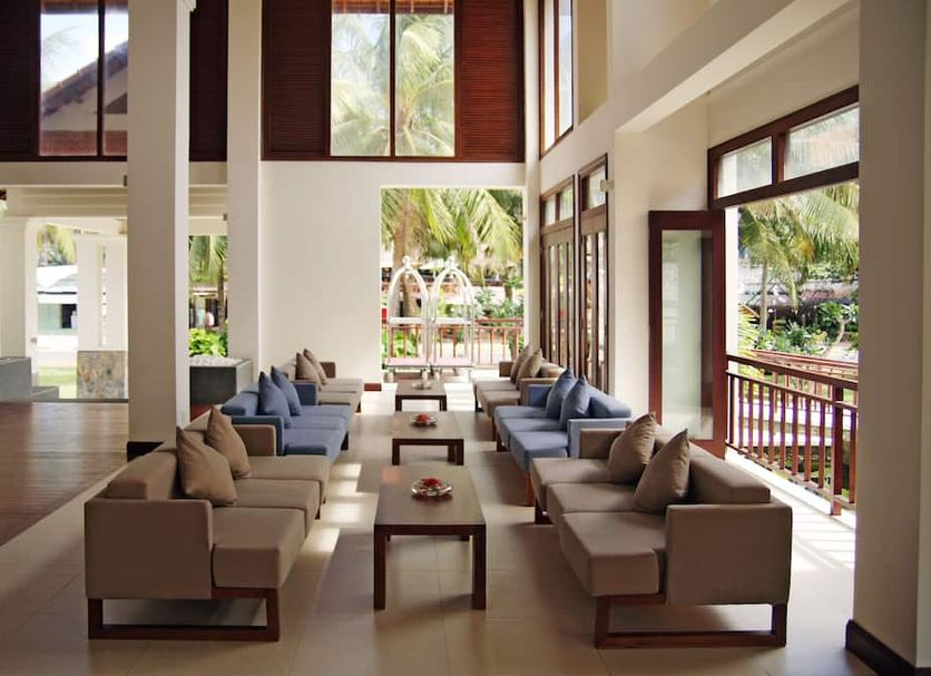 Blue Ocean Resort Phan Thiet lobby lounge with sofas, tall windows and tropical garden views