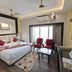 Hotel Sagar Kanya Inn, Puri: guest room with double bed, seating area, TV, and balcony doors