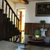 Hostal Los Volcanes in Guatemala City lobby with staircase, floral arrangements, and glass coffee table