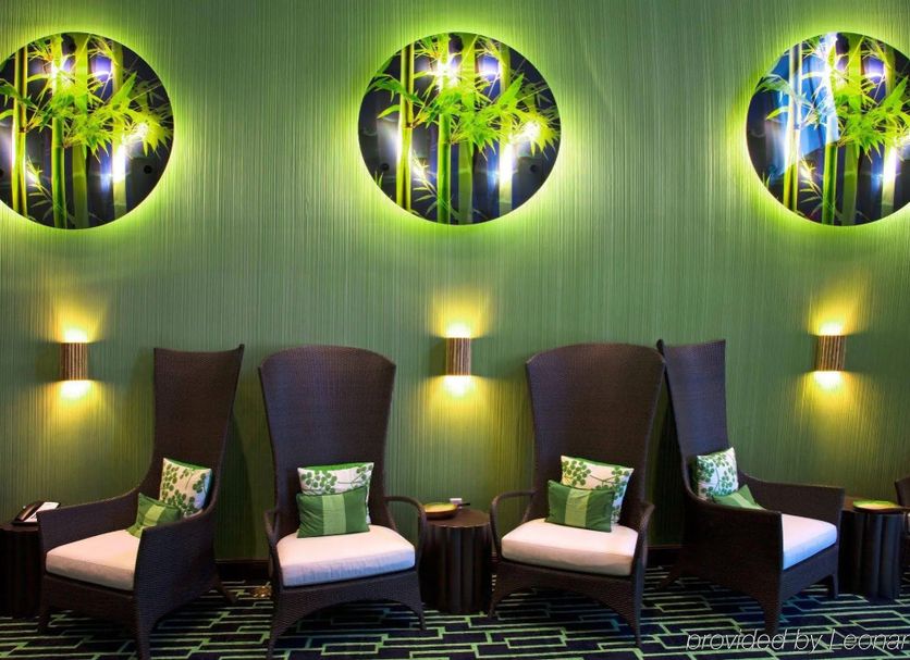 Holiday Inn Express & Suites Orlando - Apopka By IHG lounge with high-back chairs and circular wall art