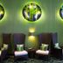 Holiday Inn Express & Suites Orlando - Apopka By IHG lounge with high-back chairs and circular wall art