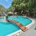 Villa Cha Cha Chaolao Beach Resort in Chanthaburi with a lagoon-style outdoor pool and wooden bridge