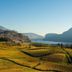 Naramata Inn in Naramata with valley vineyard views and distant lake and mountain backdrop