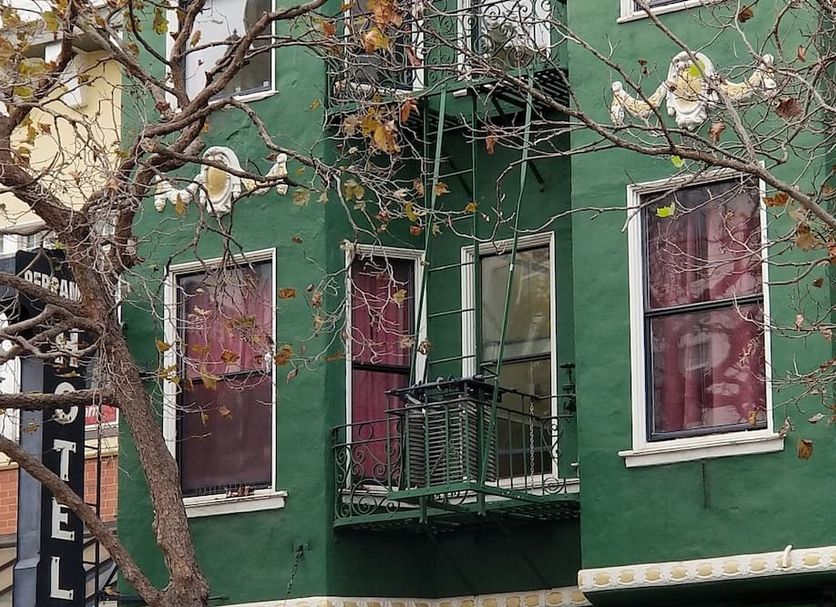 Perramont Hotel in San Francisco, green facade with bay windows and small iron balconies
