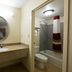 Red Roof Inn Virginia Beach - Norfolk Airport bathroom with vanity, mirror, sink, toilet, and shower curtain