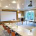 Langwies Genussherberge in Vigaun meeting room with U-shaped tables, projector screen and garden doors
