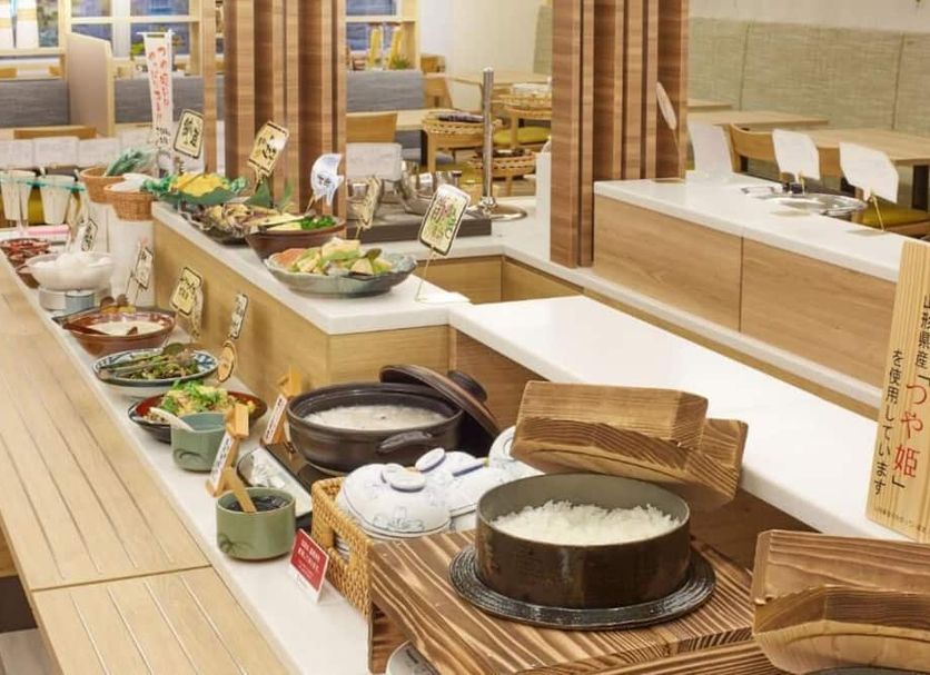 Richmond Hotel Yamagata Ekimae buffet counter with rice pot, assorted dishes, and dining trays in Yamagata