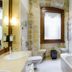 Sercotel Puerta de la Catedral bathroom in Salamanca with bathtub, toilet, sink, and frosted window