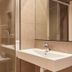 Hotel Berri Versalles bathroom with glass shower enclosure, wall mirror, and white sink in Errenteria