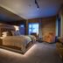 Skarsnuten Mountain Resort & Spa in Hemsedal bedroom with mountain-view window and lounge chairs