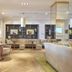 Dona Filipa Hotel, Almancil: elegant lounge with upholstered chairs, sofa, and shelving