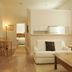 Casa 325 in Key West: bright suite with white sofa, wood floors, and glimpse of a bedroom