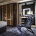 Hotel Les Bains Paris room with canopy bed and sculptural lounge chair in Paris