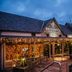 The Torrance Hotel Glasgow exterior at dusk with warm string lights and a covered entrance