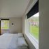 Seydisfjördur Guesthouse room with bed and large windows overlooking Seydisfjordur hillside