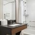 Fairfield Inn & Suites by Marriott Sacramento Airport Natomas bathroom with vanity, shower, and bathtub