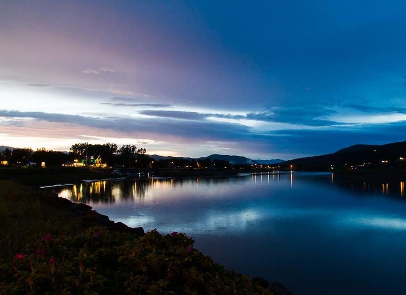 Domaine Belle Plage in Baie-Saint-Paul with serene waterfront and twilight sky reflections