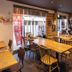 Apa Hotel Koriyama Ekimae dining area in Kōriyama with wooden tables, chairs, and street-facing windows