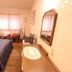 Hot Spring Hakuba Symphony guest room in Hakuba with bed, window seating, and wooden dresser