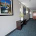 Wingate by Wyndham Indianapolis Airport Plainfield hallway with elevator and framed wall art