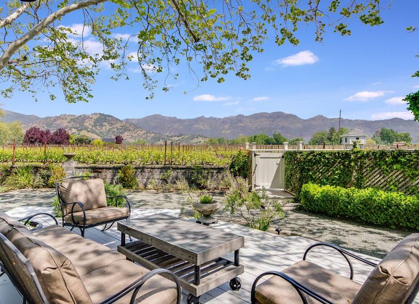 Chateau de Vie Calistoga courtyard patio with seating, mountains and vineyard views