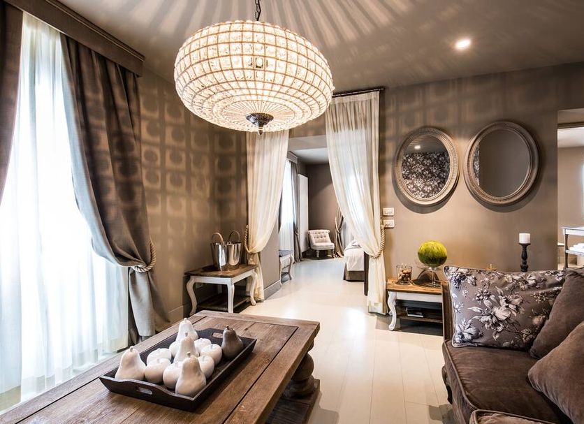 Meltar Boutique Hotel Asiago lounge with chandelier, draped windows, sofa, coffee table, and seating area