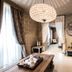 Meltar Boutique Hotel Asiago lounge with chandelier, draped windows, sofa, coffee table, and seating area