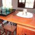 Pousada Innova in Natal dining table with stools, plates, glasses and cups in a bright room