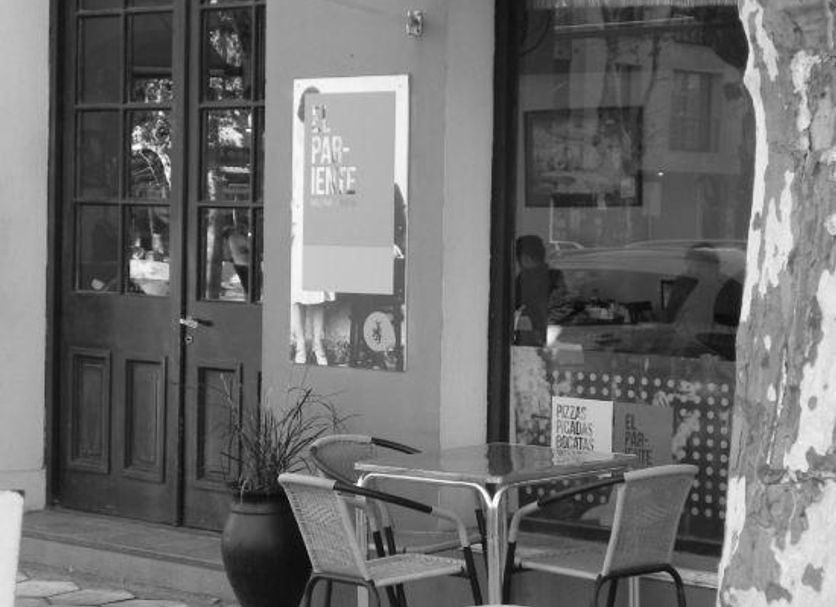 Hotel Beltran in Colonia del Sacramento exterior seating by a glass-front entrance