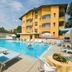 Hotel & Residence Parador in Cesenatico with outdoor pool, sun loungers, and yellow hotel facade