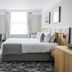Victory House London guest room with double bed, desk, wall-mounted TV and window in London
