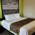Super 8 by Wyndham Nebraska City guest room with bed, nightstand, lamp and framed wall art