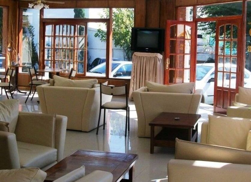 San Remo Palace Hotel, Villa Gesell lobby with lounge seating and large windows facing the street