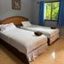 Aonang Sr Bungalow in Ao Nang room with two twin beds and window view of greenery