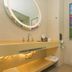 Lavande Hotel Yichang Baota River Wanda bathroom with round mirror, wall art and toilet