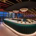 W Sydney rooftop bar with curved counter and Sydney skyline view at sunset