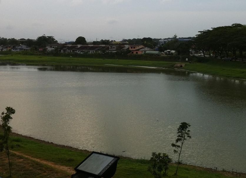 City Star Hotel Kulai in Kulai overlooks a calm lake with grassy banks and trees