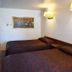 JR Inn in Soda Springs guest room with two beds and wall-mounted lamps