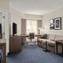 Residence Inn by Marriott Chicago Naperville/Warrenville guest suite with sofa, desk, TV and window view
