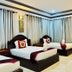 Golden Bakong Boutique Siem Reap guest room with three single beds and curtained windows