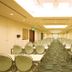 Smile Hotel Kumagaya meeting room in Kumagaya with rows of tables and green chairs