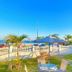 Hostel Dos Gringos in Maricá with ocean-view patio, lawn seating, and blue sky