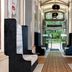 Leonardo Boutique Hotel Krakow Old Town lobby corridor with upholstered seating and glass doors to garden
