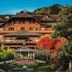 Hotel Casa da Montanha in Gramado with a gazebo and landscaped gardens in front of the lodge-style facade