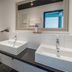 Best Western Hotel Würzburg Sued bathroom with double sinks, toilet, shower and large mirror in Wurzburg